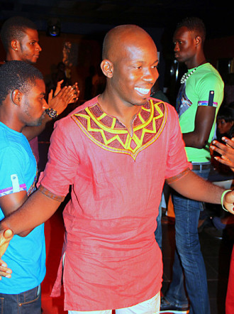 Atsu Numadzi pictured candidly at a party wearing a red shirt